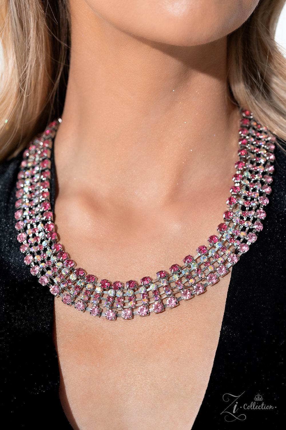 Paparazzi Accessories Flirtatious - Pink Row after row of glittery pink rhinestones fall along flexible bands of silver, encircling the neck in stunning shimmer. The top row showcases a fierce shade of fuchsia, which contrasts beautifully with the iridesc