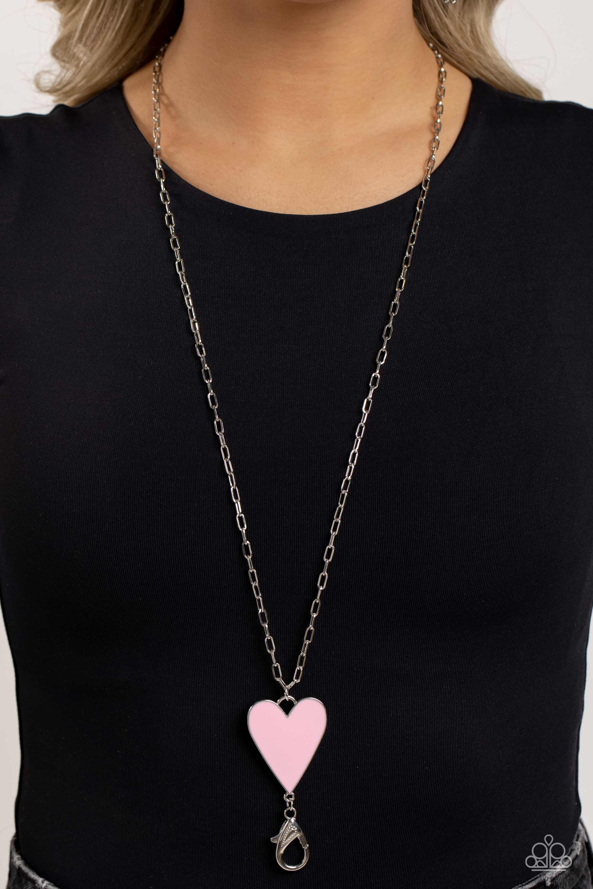 Paparazzi Accessories Subtle Soulmate - Pink *Lanyard Shiny silver oval links coalesce down the neck on an elongated chain, meeting a baby pink heart pendant wrapped in an understated silver frame for a colorfully romantic finish. A lobster clasp hangs fr