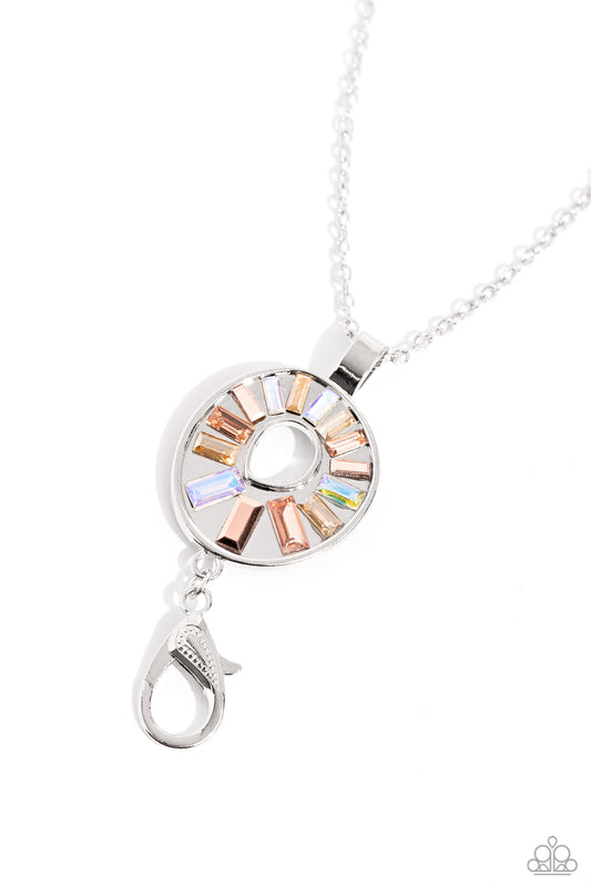 Paparazzi Accessories Wreathed in Artistry - Multi Featuring a UV shimmer, an explosion of glassy, emerald-cut gems in varying shades of peach and iridescence fan out from an asymmetrical circular silver frame, attached to an elongated silver chain for an