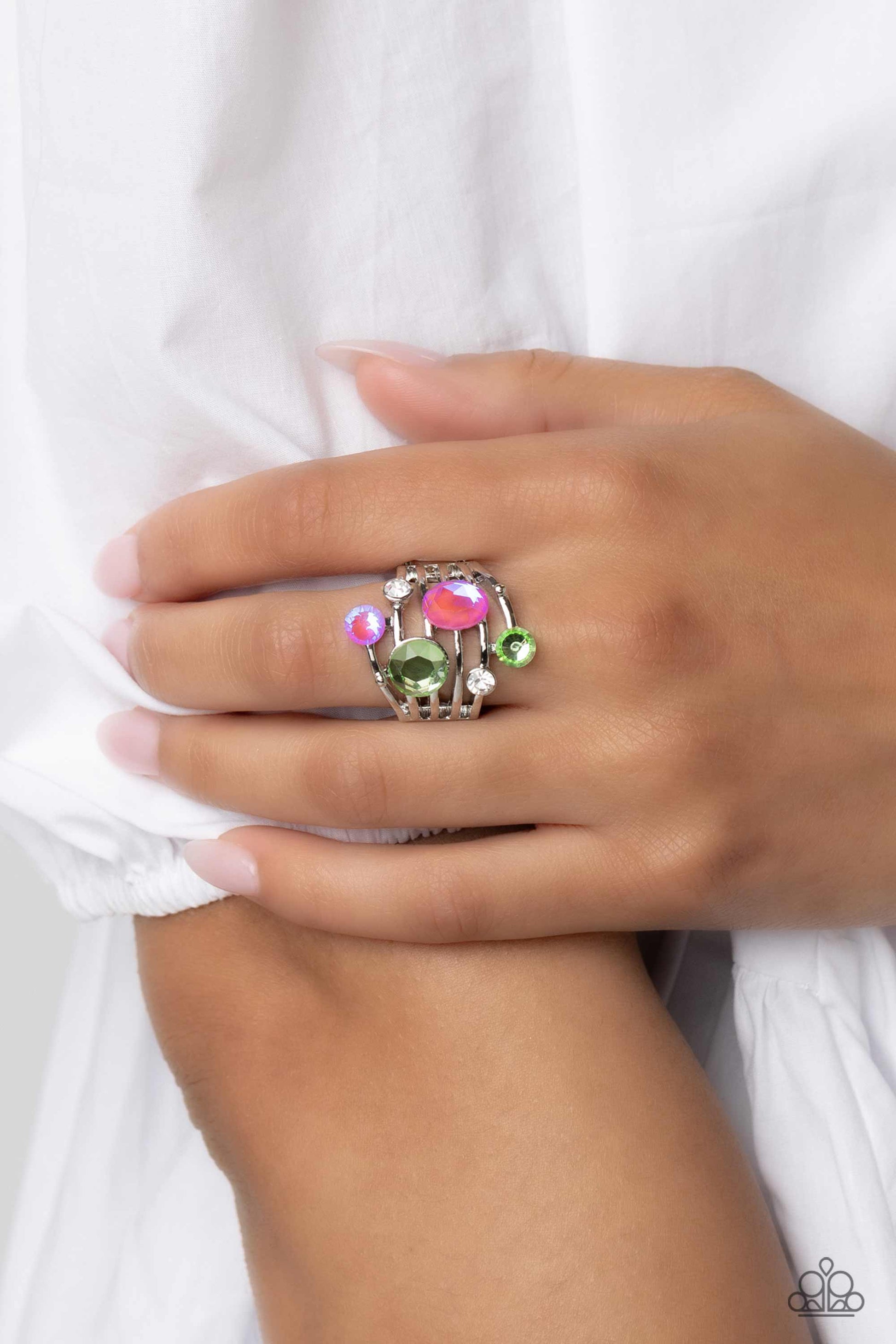 Paparazzi Accessories Timeless Trickle - Green Featuring a refined sheen, smooth silver bars arc across the finger, creating an airy band. Glittery green, pink, and white rhinestones of various sizes and shapes are sprinkled haphazardly across the glisten