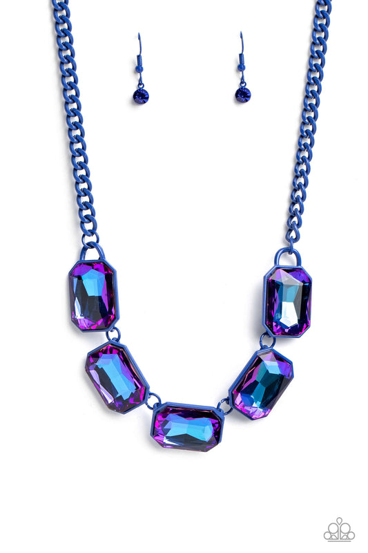 Paparazzi Accessories Emerald City Couture - Blue Featuring a vivacious blue chain, a collection of purple UV shimmery emerald-cut gems, pressed in vibrant blue frames, coalesces around the collar to create a playful pop of edgy color. Features an adjusta