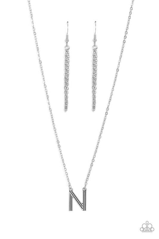 Paparazzi Accessories Leave Your Initials - Silver - N Etched in linear texture, a silver letter "N" hovers below the collar from a dainty silver chain, for a sentimentally simple design. Features an adjustable clasp closure. Sold as one individual neckla