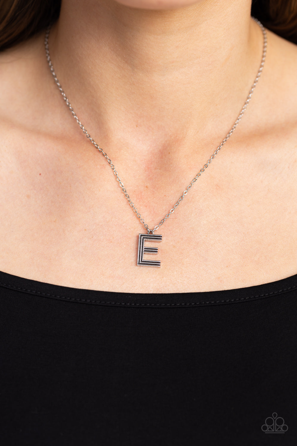 Paparazzi Accessories Leave Your Initials - Silver - E Etched in linear texture, a silver letter "E" hovers below the collar from a dainty silver chain, for a sentimentally simple design. Features an adjustable clasp closure. Sold as one individual neckla