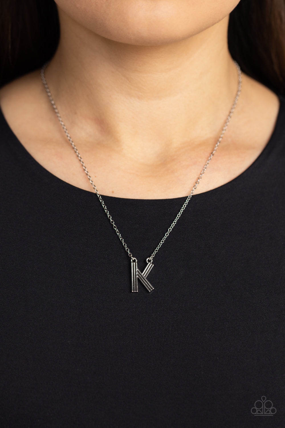 Paparazzi Accessories Leave Your Initials - Silver - K Etched in linear texture, a silver letter "K" hovers below the collar from a dainty silver chain, for a sentimentally simple design. Features an adjustable clasp closure. Sold as one individual neckla