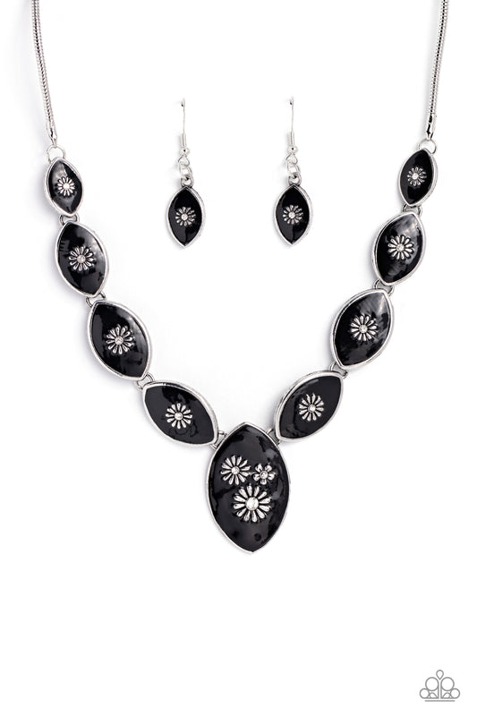 Paparazzi Accessories Pressed Flowers - Black Featuring intense black paint, a collection of silver marquise-shaped frames gradually increase in size as they taper below the collar in a timeless fashion on a silver snake chain. Each frame is embossed with