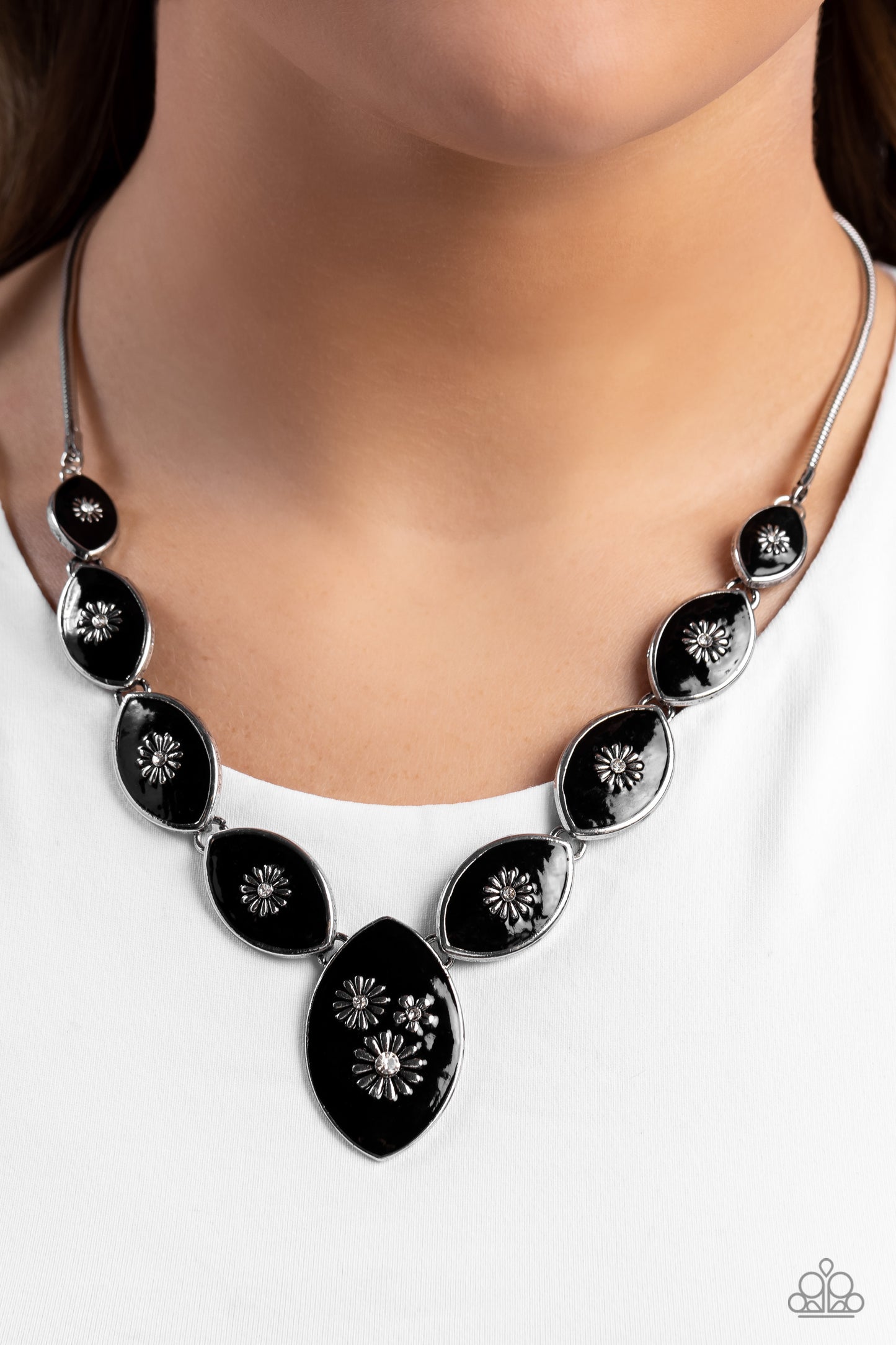 Paparazzi Accessories Pressed Flowers - Black Featuring intense black paint, a collection of silver marquise-shaped frames gradually increase in size as they taper below the collar in a timeless fashion on a silver snake chain. Each frame is embossed with