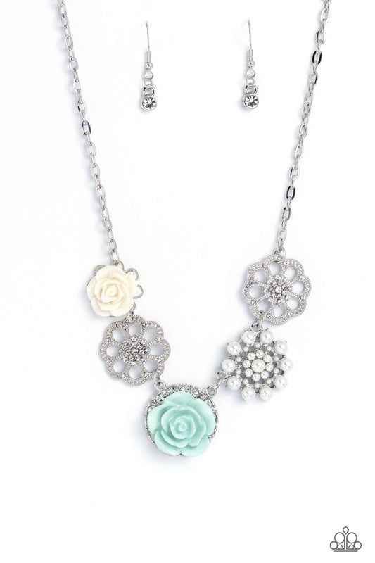 Paparazzi Accessories Tea Party Favors - Blue A collection of whimsical, refined flowers gathers along a flat, sleek silver link chain. The featured charms include an ivory resin rose blooming atop a glittery silver floral silhouette, two silver flowers d
