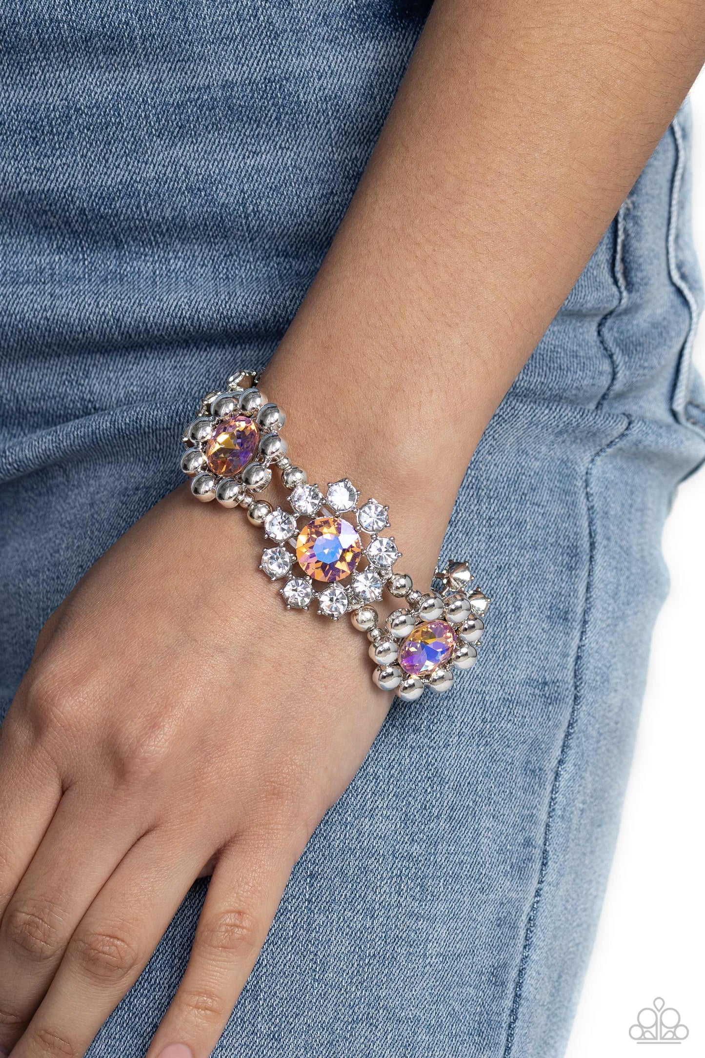 Paparazzi Accessories Pact of Petals - Orange Scattering around faceted peach rhinestones, pronged white-gem petals and faceted silver beaded petals alternate along stretchy bands resulting in regally refined floral frames that wrap around the wrist. Sold