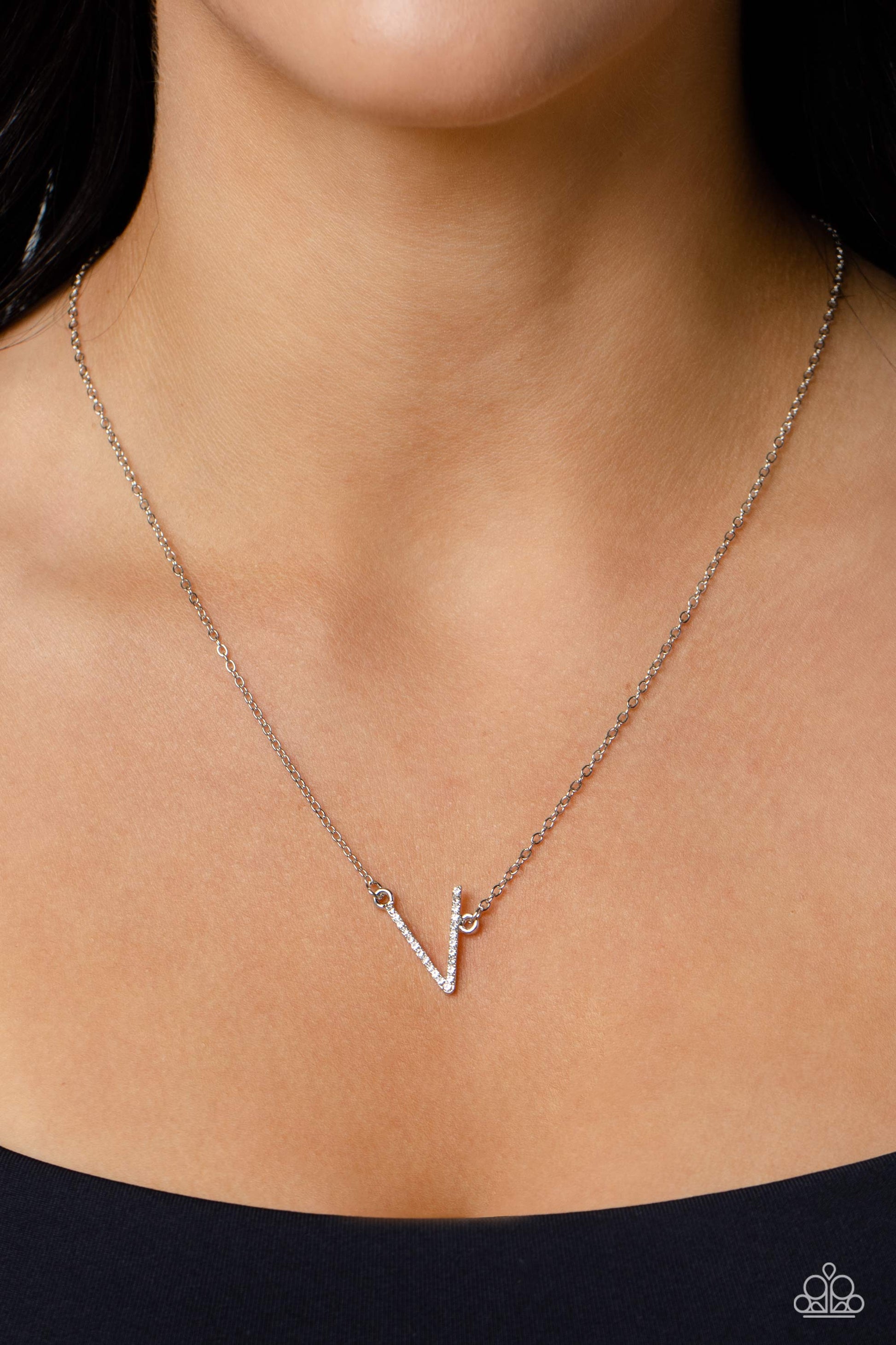 Paparazzi Accessories INITIALLY Yours - V - White Embossed with dainty white rhinestones, a silver letter "V" hovers below the collar from a dainty silver chain, for a sentimentally simple design. Features an adjustable clasp closure. Sold as one individu
