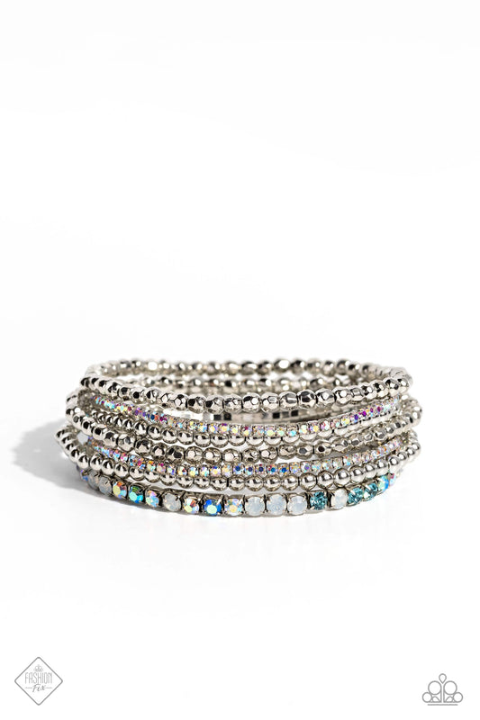 Paparazzi Accessories Stellar Sequence - Blue A mismatched collection of smooth and faceted silver beads collides with strands of aquamarine, opalescent, blue iridescent, and iridescent rhinestones set in square fittings to create an irresistibly stellar