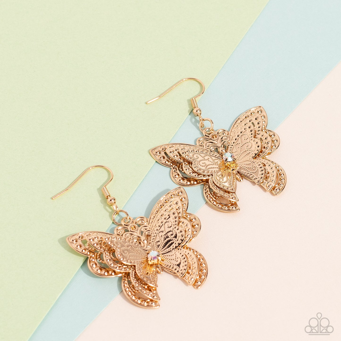 Paparazzi Accessories Layered Launch - Multi A whimsical 3D butterfly, with ornate details and textures, elegantly increases in size to create a three-layered high-sheen gold lure. An iridescent gem is nestled at the center of the butterfly's wings, creat