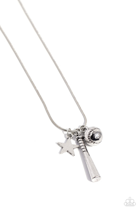 Paparazzi Accessories Hey Batter Batter! - Silver An assortment of charms, including a star, baseball, and baseball bat, glide along a dainty silver snake chain, creating a simply sporty display below the collar. Features an adjustable clasp closure. Sold