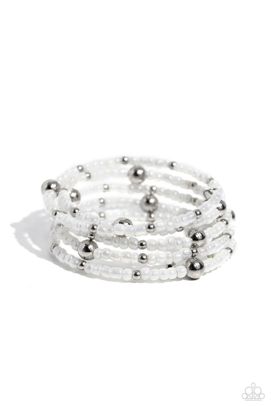 Paparazzi Accessories Refined Retrograde - White Pearly white seed beads, and various-sized silver accents are threaded along a coiled wire, creating a refined infinity wrap-style bracelet around the wrist. Sold as one individual bracelet Jewelry