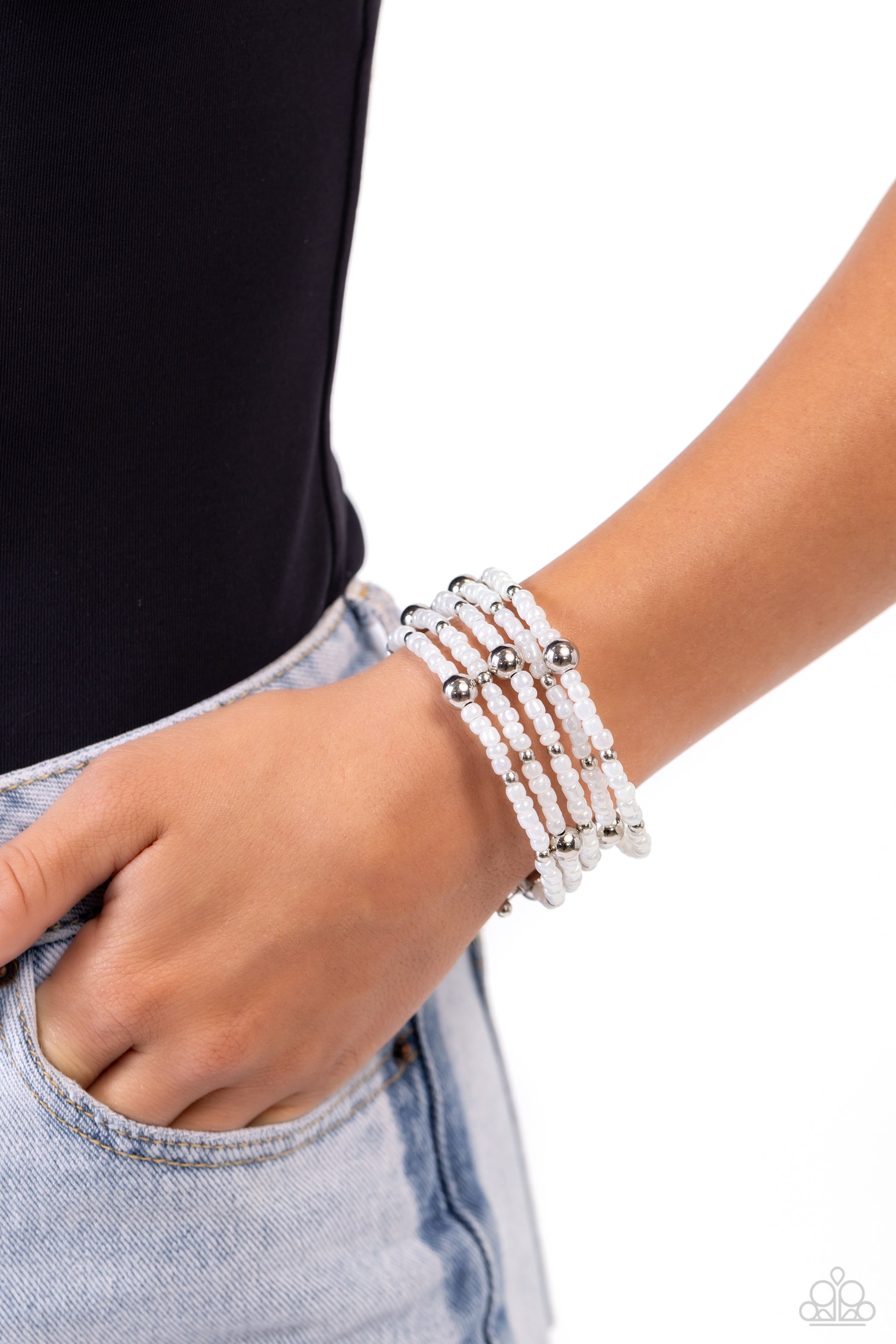 Paparazzi Accessories Refined Retrograde - White Pearly white seed beads, and various-sized silver accents are threaded along a coiled wire, creating a refined infinity wrap-style bracelet around the wrist. Sold as one individual bracelet Jewelry
