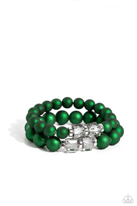 Paparazzi Accessories Shopaholic Showdown - Green Two strands of oversized emerald green beads featuring a subtle shimmer, silver accents, and clear gray cubed beads stretch around the wrist, creating refined, colorful layers. Sold as one set of two brace
