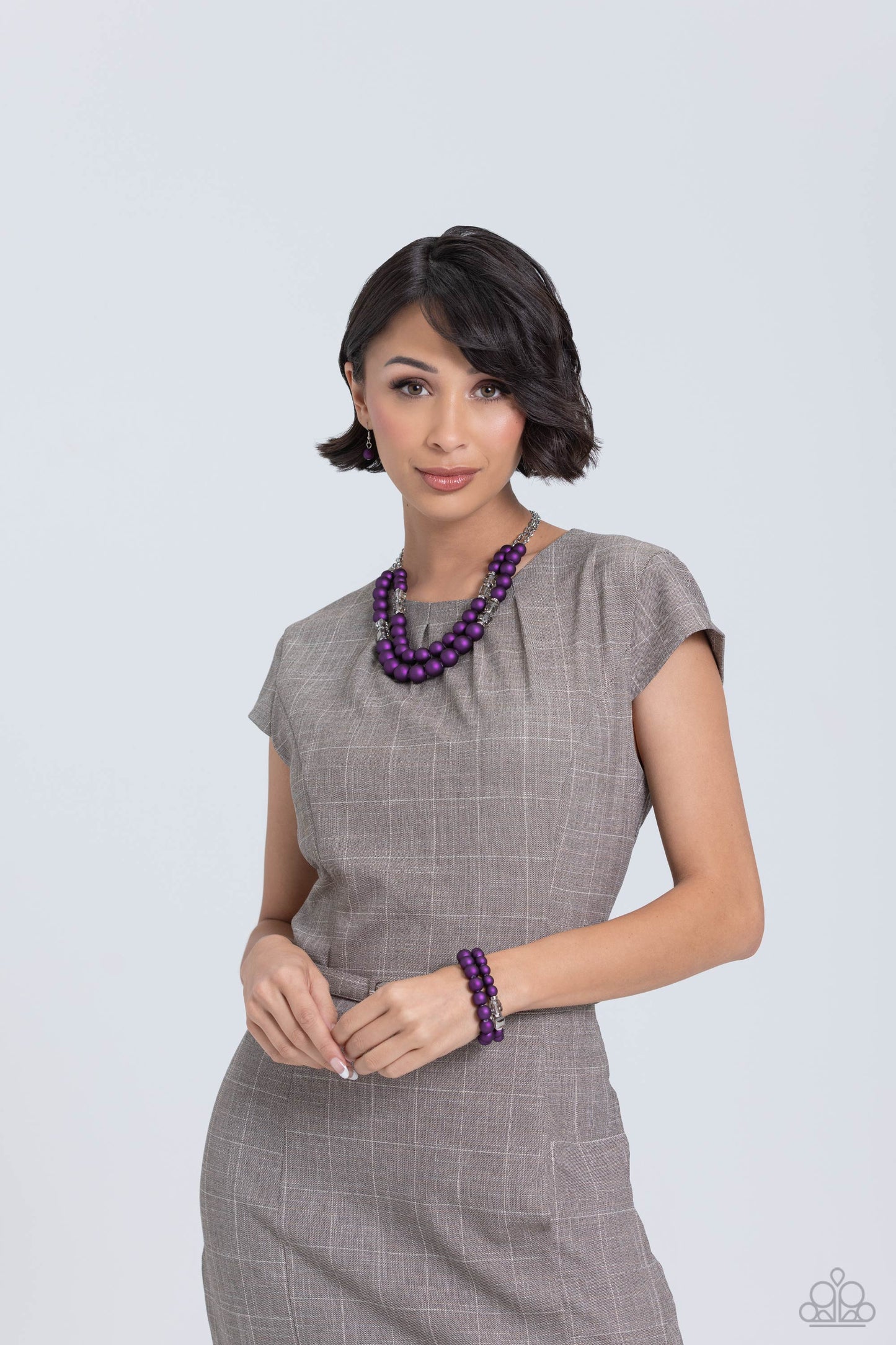 Paparazzi Accessories Shopaholic Season - Purple Two rows of oversized purple beads featuring a subtle shimmer, silver accents, and clear gray cubed beads fall below the collar on silver paperclip chains, creating refined, colorful layers. Features an adj