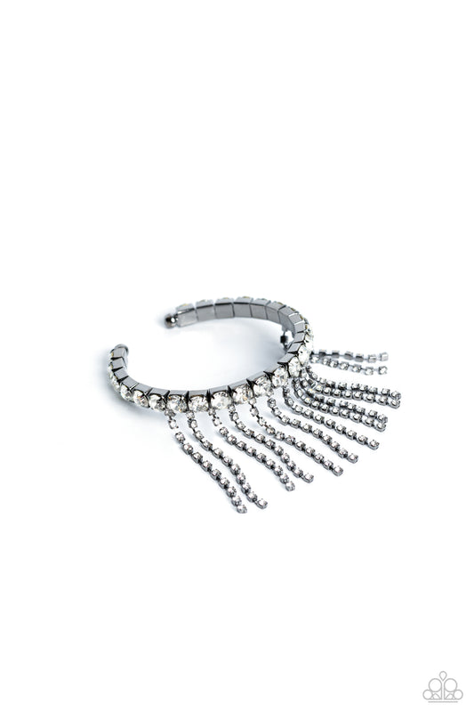 Paparazzi Accessories Stardust Shower - Black Pressed in thick gunmetal square fittings, white gems encircle the wrist to create a glittery cuff. Rows of dainty white rhinestones, pressed in delicate gunmetal square fittings, cascade from the sparkly cuff