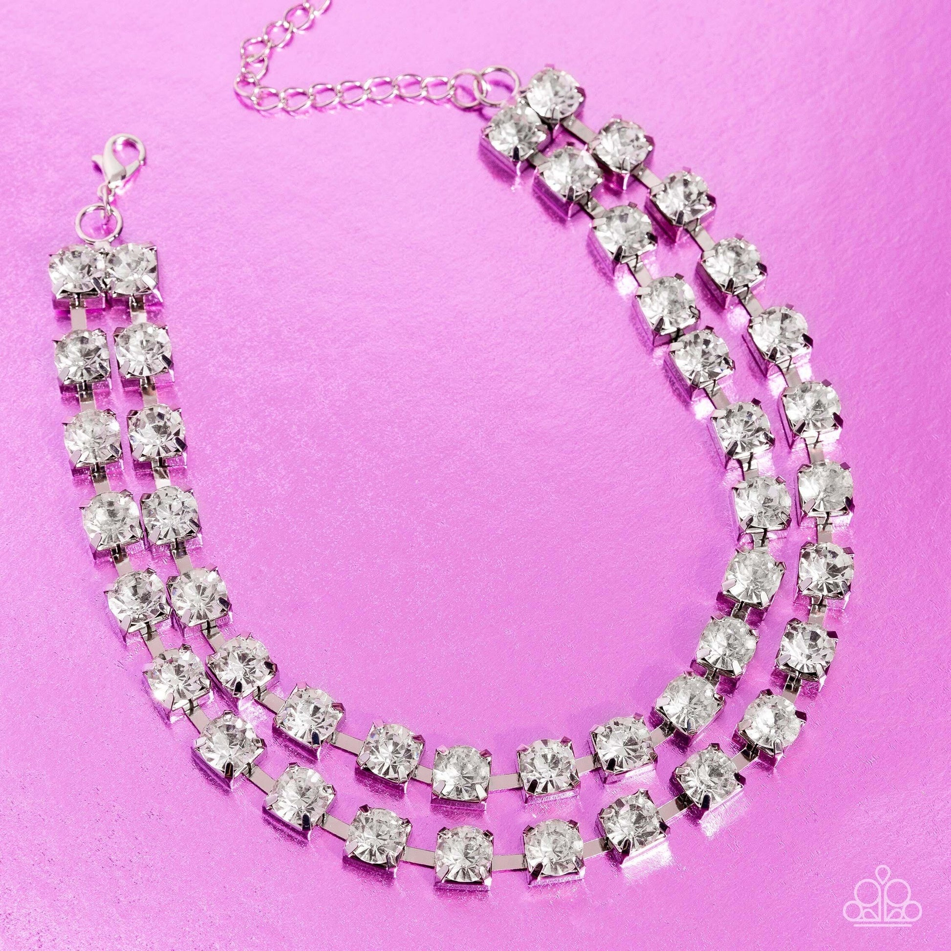 Paparazzi Accessories Glistening Gallery - White Featuring pronged silver fittings, strands of oversized, glittery white rhinestones connect with rows of silver box chains around the neck for a glittery twist. Features an adjustable clasp closure. Sold as