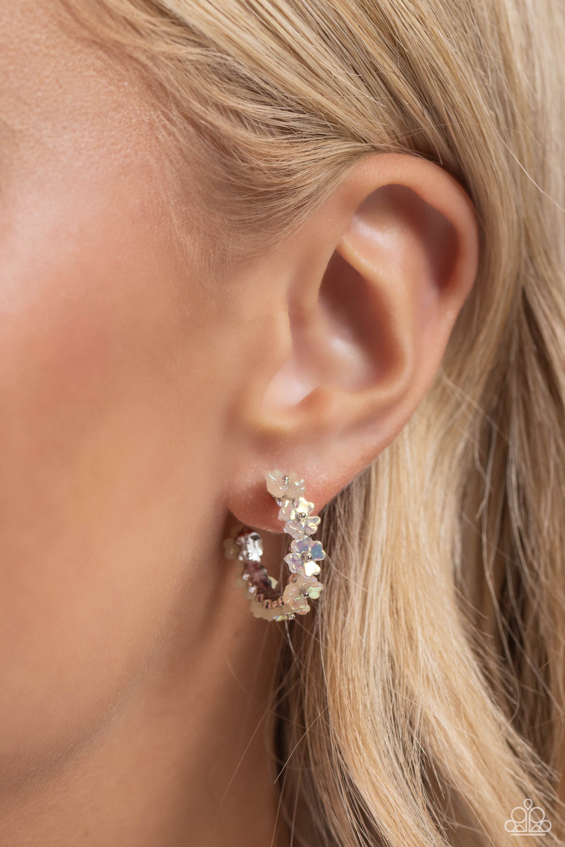 Paparazzi Accessories Floral Focus - White Tiny white iridescent flowers connect to one another as they wrap around the ear to create a charming, dainty hoop. Earring attaches to a standard post fitting. Hoop measures approximately 3/4" in diameter. Due t