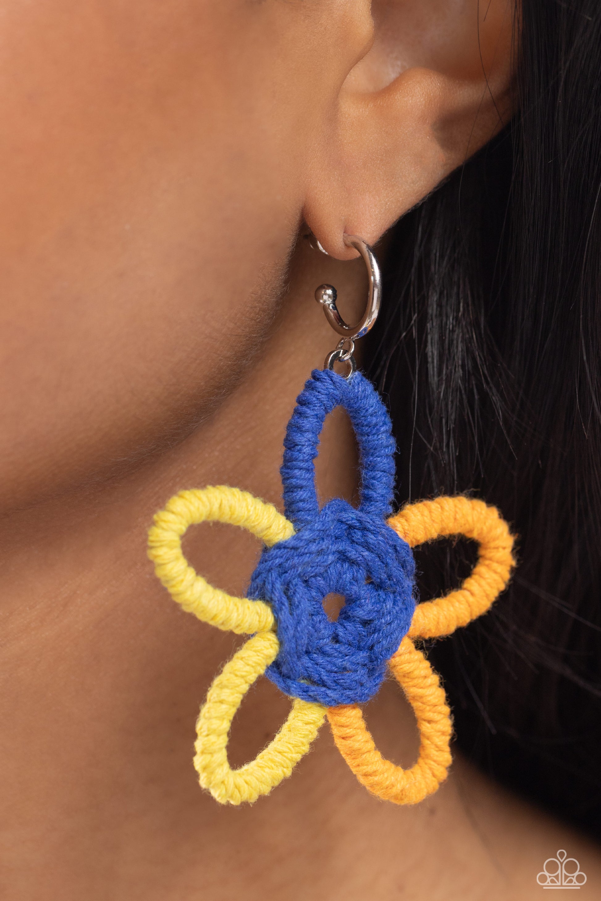 Paparazzi Accessories Spin a Yarn - Orange Featuring High Visibility, Persian Jewel, and orange yarn, an oversized flower swings freely from a dainty silver hoop, creating a playful lure. Earring attaches to a standard post fitting. Hoop measures approxim