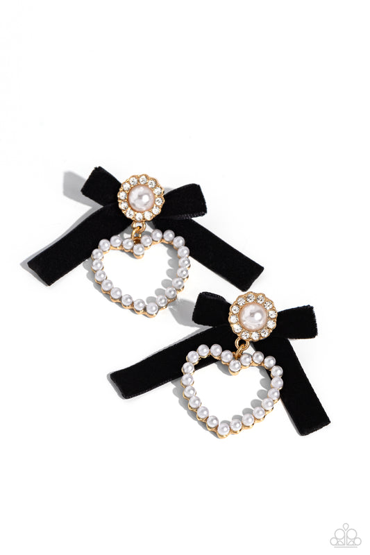 Paparazzi Accessories BOW and Then - Gold A solitaire white pearl, pressed in a white rhinestone-encrusted gold hoop, gleams atop a pearl-dotted heart frame resulting in a dazzling statement piece. A black velvet ribbon fans out from the pearly centerpiec