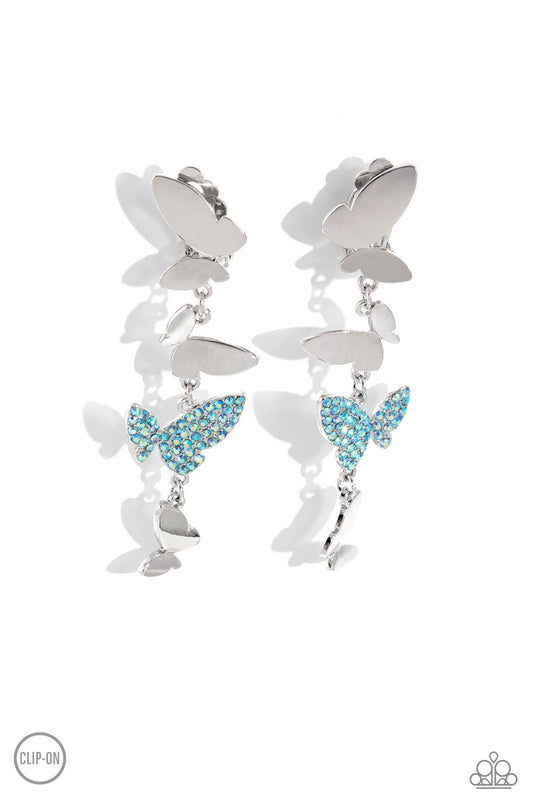 Paparazzi Accessories Flying Flashy - Blue *Clip-On Three butterflies with high-sheen silver wings and one blue iridescent-encrusted butterfly flutter down the ear, creating a free-spirited lure. Each butterfly swings in whimsical asymmetry, creating the