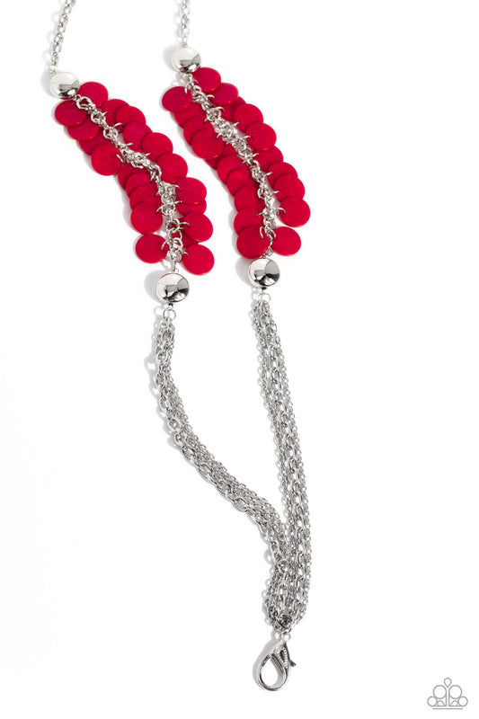 Paparazzi Accessories Shell Sensation - Red Flared between two oversized silver beads, a collection of red shell-like beads give way to sections of silver chains that connect across the chest for a colorful summery look. A lobster clasp hangs from the bot