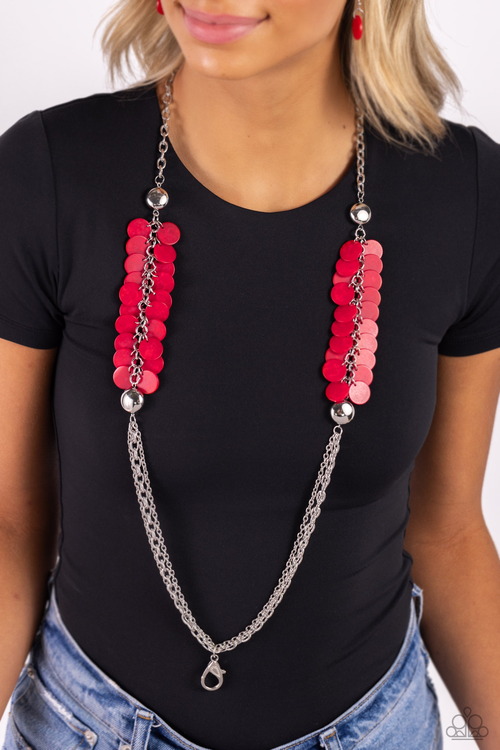 Paparazzi Accessories Shell Sensation - Red Flared between two oversized silver beads, a collection of red shell-like beads give way to sections of silver chains that connect across the chest for a colorful summery look. A lobster clasp hangs from the bot