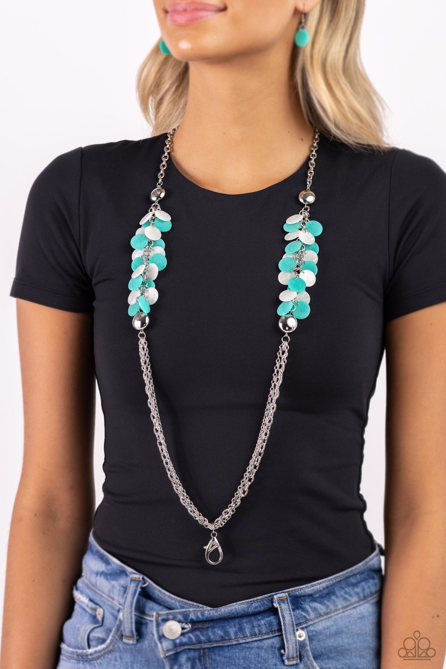 Paparazzi Accessories Shell Sensation - Green *Lanyard Flared between two oversized silver beads, a collection of turquoise and white shell-like beads give way to sections of silver chains that connect across the chest for a colorful summery look. A lobst