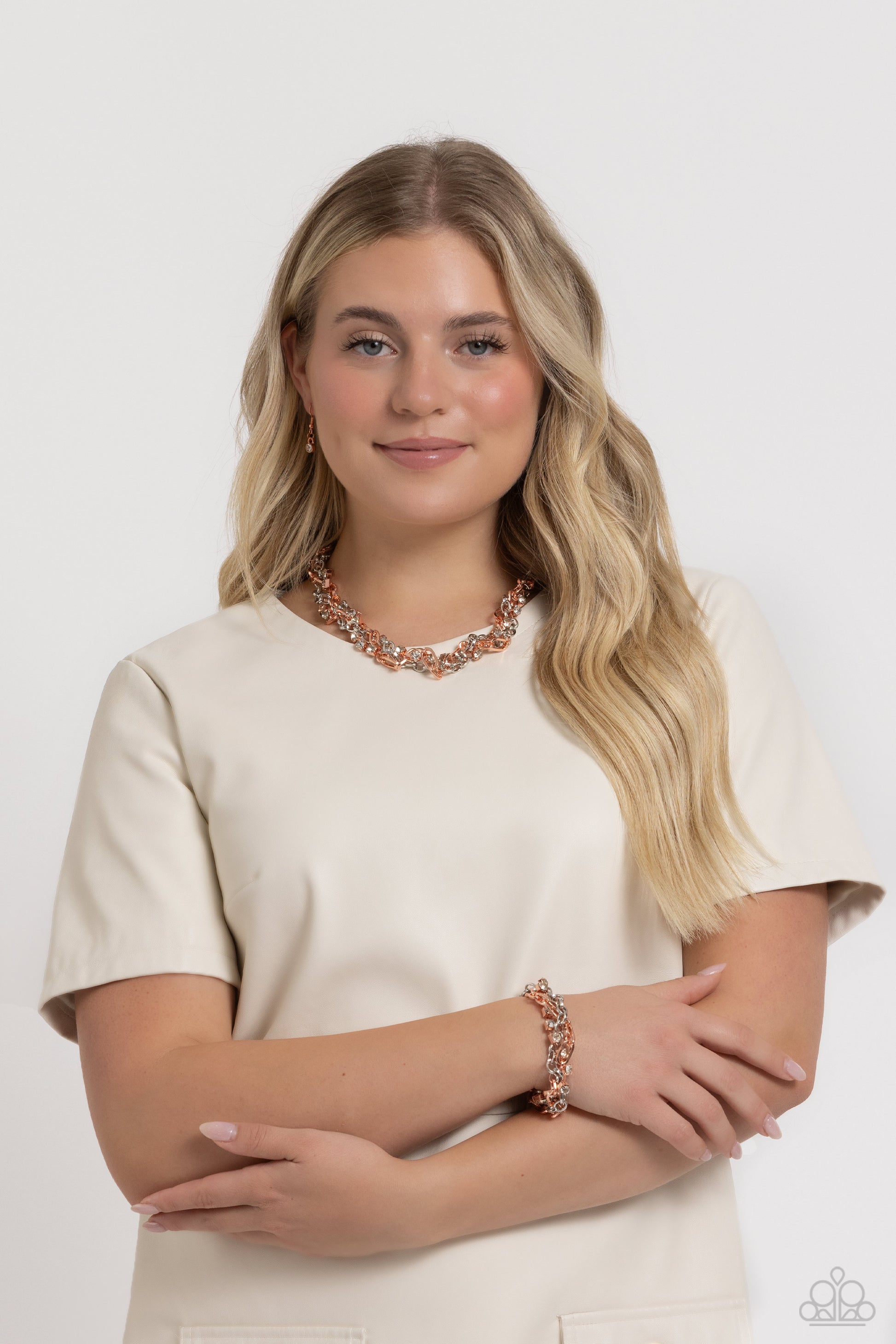Paparazzi Accessories Two-Tone Taste - Copper Mismatched strands of glistening shiny copper and silver oval links are intertwined with a row of sparkling, square-cut, white rhinestones encased in sleek shiny copper fittings, resulting in a twisted collisi
