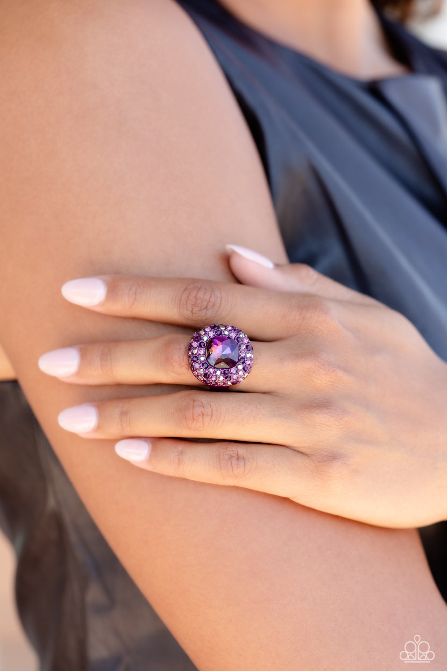 Paparazzi Accessories Glistening Grit - Purple Featuring a regal square cut, an oversized plum gem nestles inside a rounded square purple metallic frame encrusted in glassy hematite, purple, and amethyst rhinestones for a dramatically glamorous look. Feat