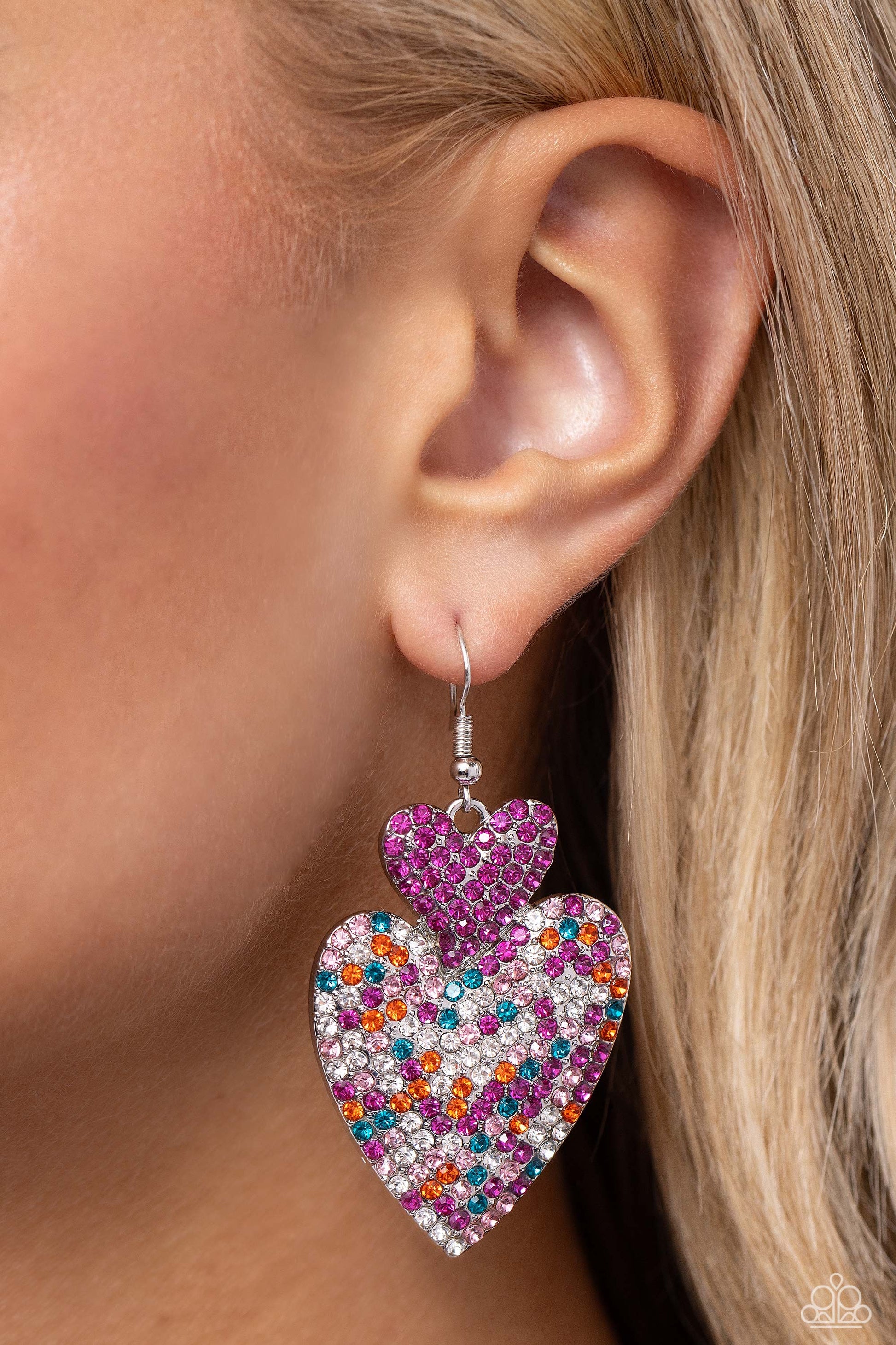 Paparazzi Accessories Flirting Flourish - Pink Embossed in dainty rhinestones, a fuchsia rhinestone-covered silver heart frame delicately links with a larger silver heart frame featuring fuchsia, light pink, blue, white, and orange rhinestones for a flirt