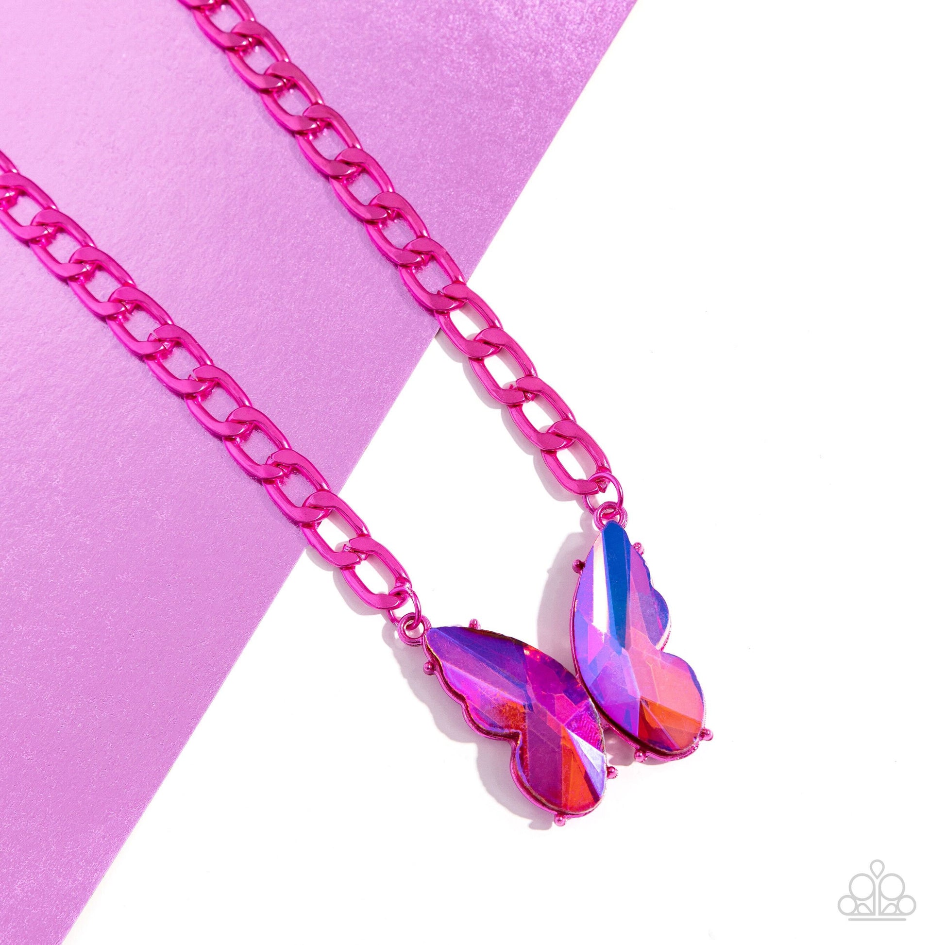 Paparazzi Accessories Fascinating Flyer - Pink Featuring a UV finish, a pair of oversized pink gem wings form into a pronged butterfly frame at the bottom of an electric pink curb chain for a vibrant, whimsical display. Features an adjustable clasp closur