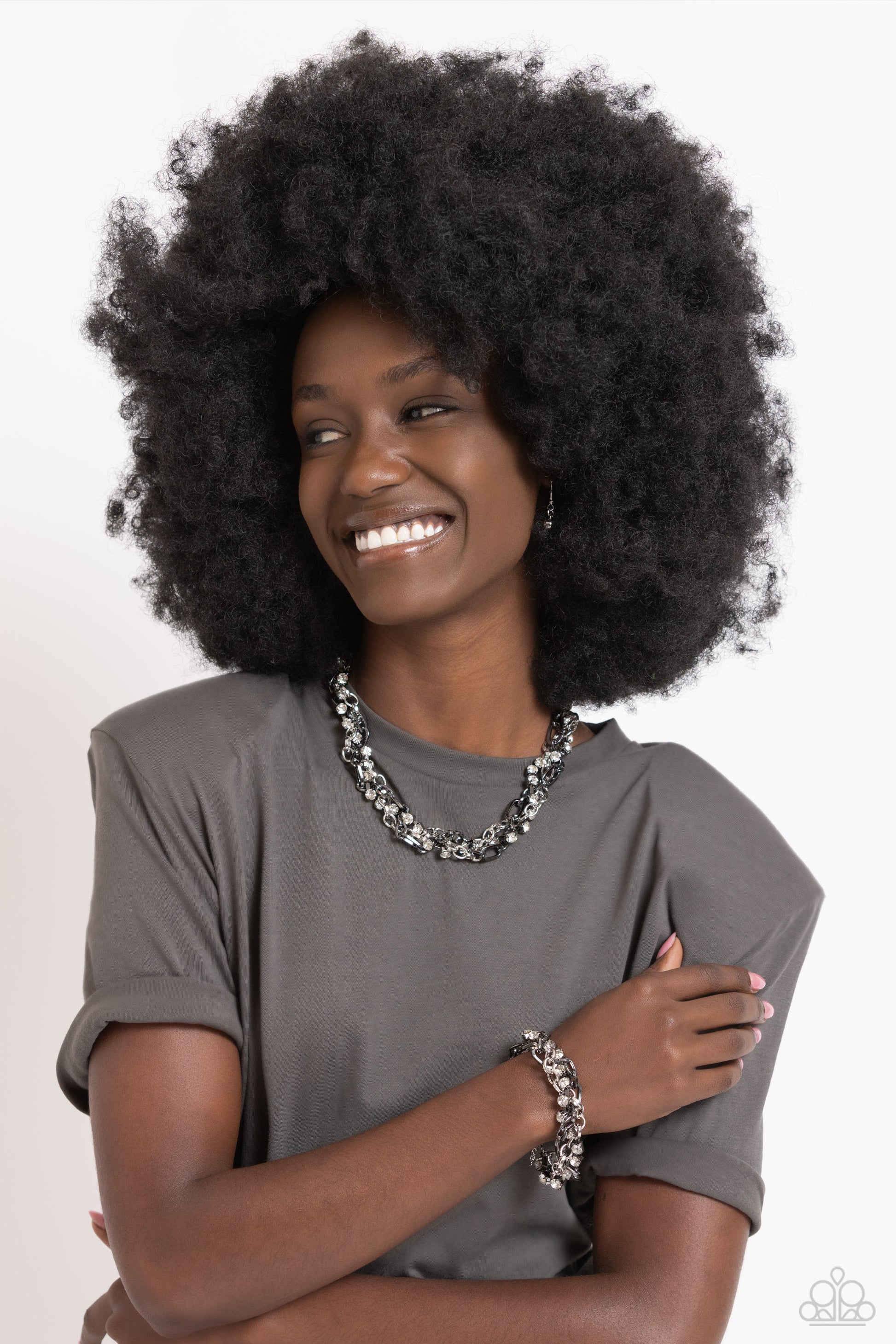 Paparazzi Accessories Two-Tone Taste - Silver Mismatched strands of glistening gunmetal and silver oval links are intertwined with a row of sparkling, square-cut, white rhinestones encased in sleek silver fittings, resulting in a twisted collision of grit