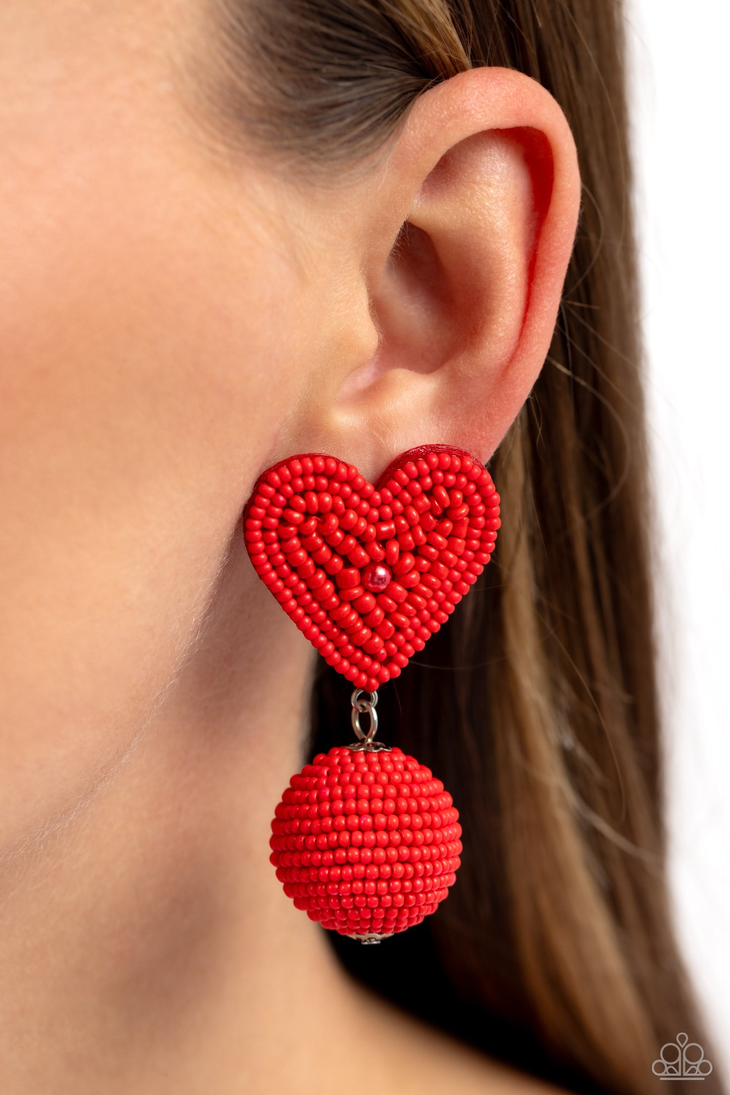 Paparazzi Accessories Spherical Sweethearts - Red Featuring a red pearl center, a red seed bead heart frame gives way to strands of red seed beads that decoratively spin around a spherical frame, resulting in a colorful three-dimensional display. Earring