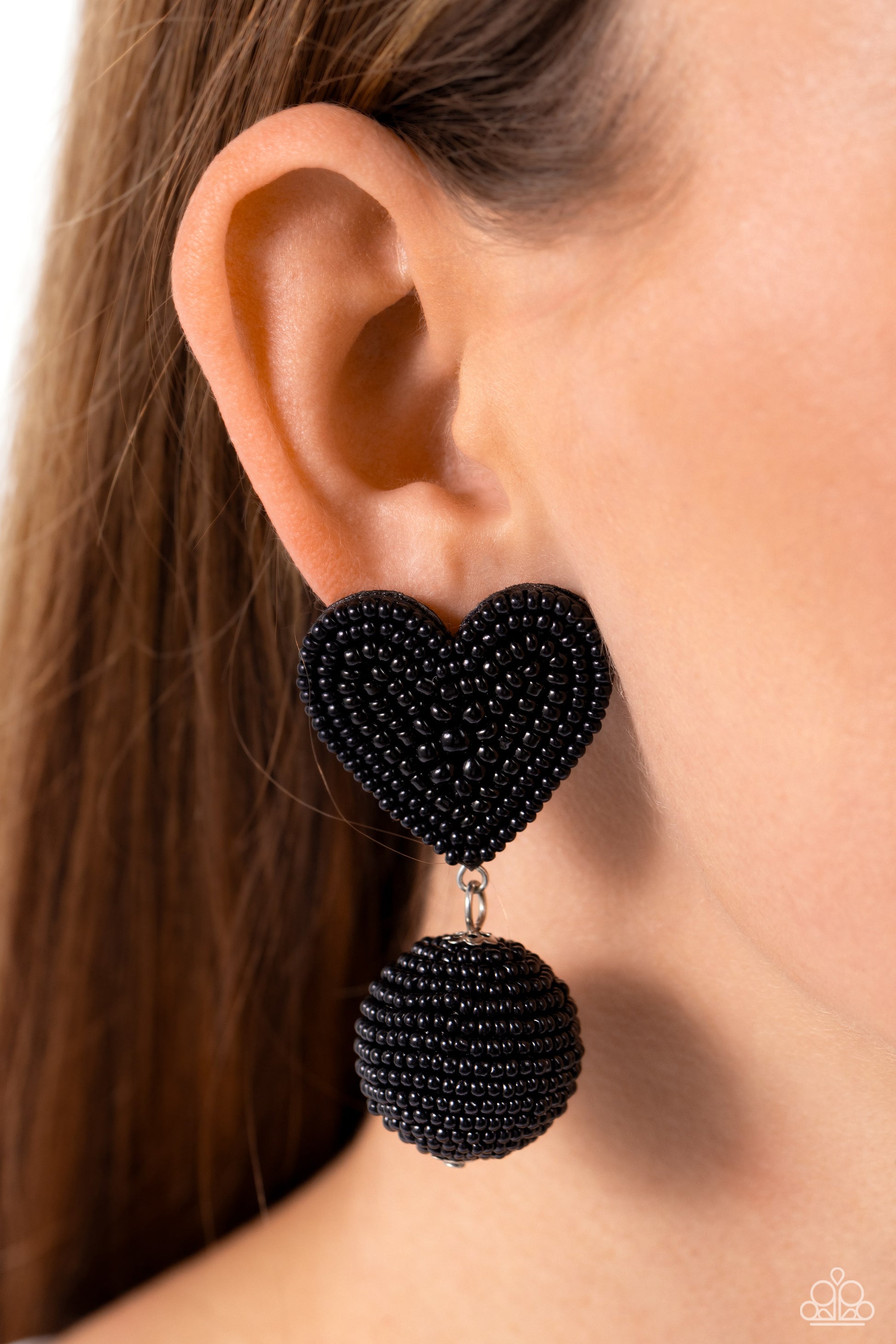 Paparazzi Accessories Spherical Sweethearts - Black A black seed bead heart frame gives way to strands of black seed beads that decoratively spin around a spherical frame, resulting in a colorful three-dimensional display. Earring attaches to a standard p