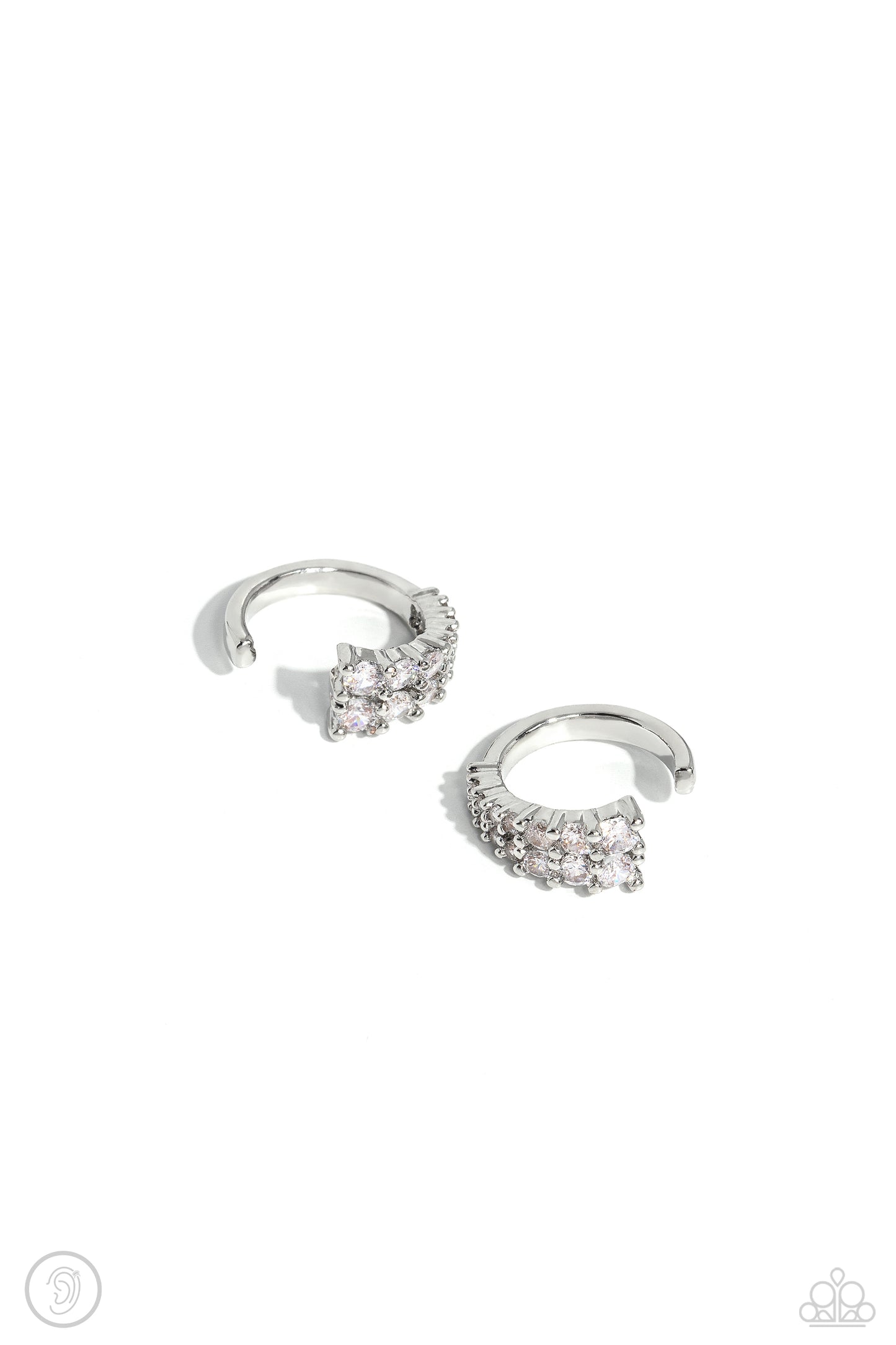 Paparazzi Accessories Pronged Parisian - White Featuring a two-pronged fitting, white rhinestones with a light iridescent sheen gradually decrease in size to create a blinding, adjustable, one-size-fits-all cuff. Sold as one pair of cuff earrings. Jewelry