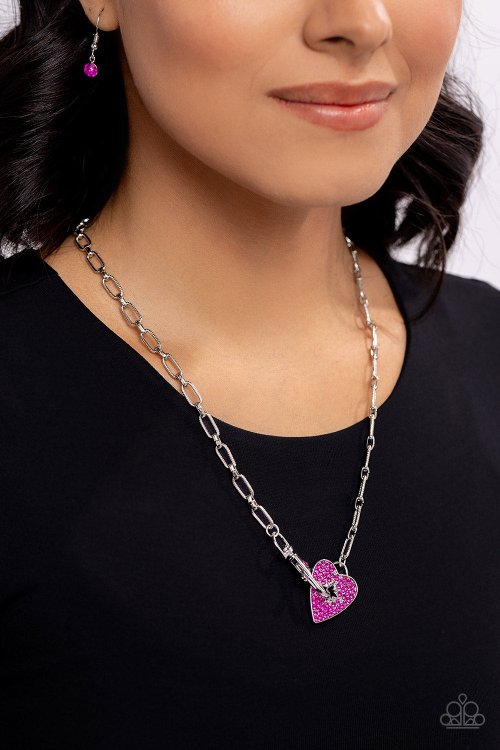 Paparazzi Accessories Radical Romance - Pink Featuring a subtly studded finish, a silver paperclip chain leads the eye down to a fuchsia rhinestone-encrusted heart. A fuchsia rhinestone-embellished lobster clasp connects to the center of the heart display