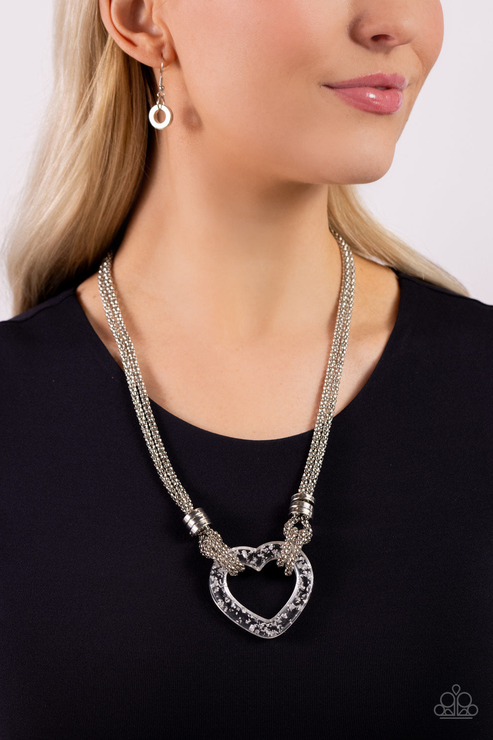 Paparazzi Accessories Lead with Your Heart - Silver Featuring a double-layered display of silver popcorn chain, a silver-flecked clear acrylic heart frame cascades down the neckline. Infused atop the acrylic heart, a trio of high-sheen silver rings adorns