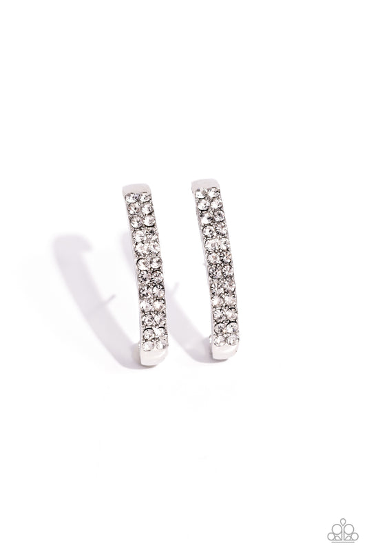 Paparazzi Accessories Sliding Series - White Two rows of glassy white rhinestones are set along the center of a curved silver bar for a refined display of dazzle. Features a sleek surface for sliding ability to desired position on the ear. Due to its stru