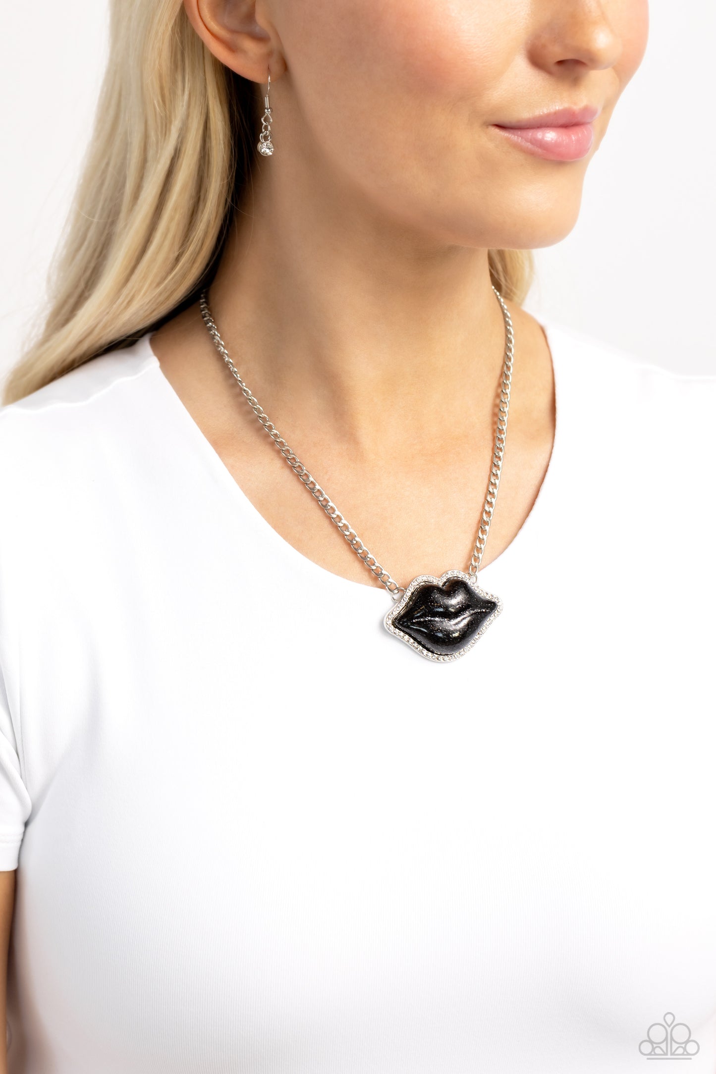 Paparazzi Accessories Lip Locked - Black Featuring a glittery finish, an oversized black lip pendant swings from the bottom of a silver link chain below the collar for a romantic statement. White rhinestones border the charm for additional stunning detail