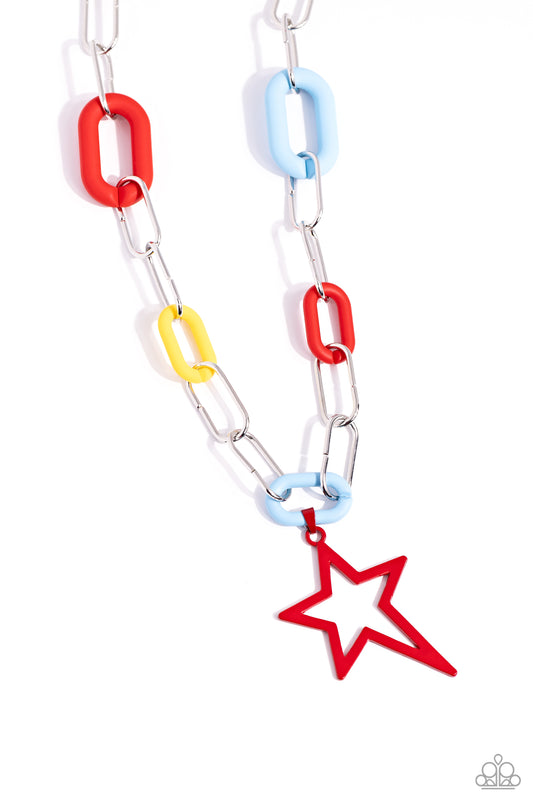 Paparazzi Accessories Stargazing Show - Red Sporadically infused with red, blue, and yellow acrylic links, an elongated silver paperclip chain featuring an asymmetrical red star gradually decreases in length as it falls down the neckline for a show-stoppi
