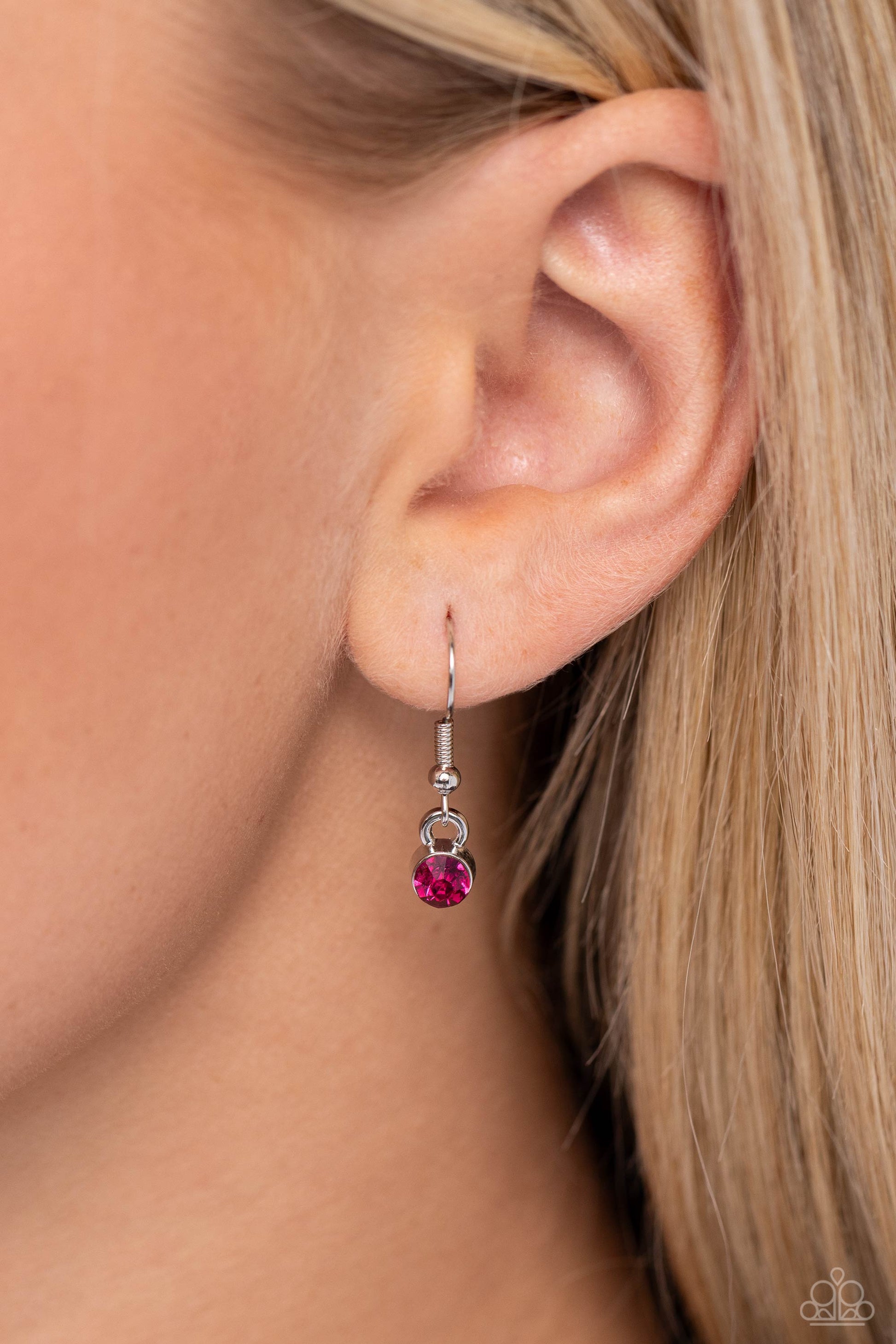 Paparazzi Accessories Sliding Splendor - Pink Featuring a lightly hammered sheen, asymmetrical silver ovals, some with airy silhouettes and exaggerated fuchsia gem centers, give off a hand-made feel as they shift and slide through multiple strands of blac