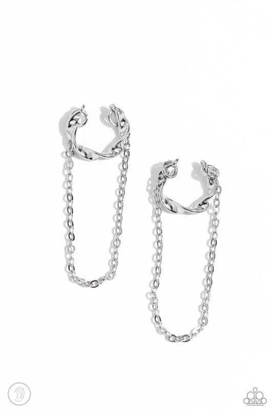 Paparazzi Accessories CUFF Hanger - Silver A glistening silver bar delicately twists into a dainty hoop while a solitaire shimmery silver chain cascades below it, creating an adjustable refined, one-size-fits-all display. Sold as one pair of cuff earrings
