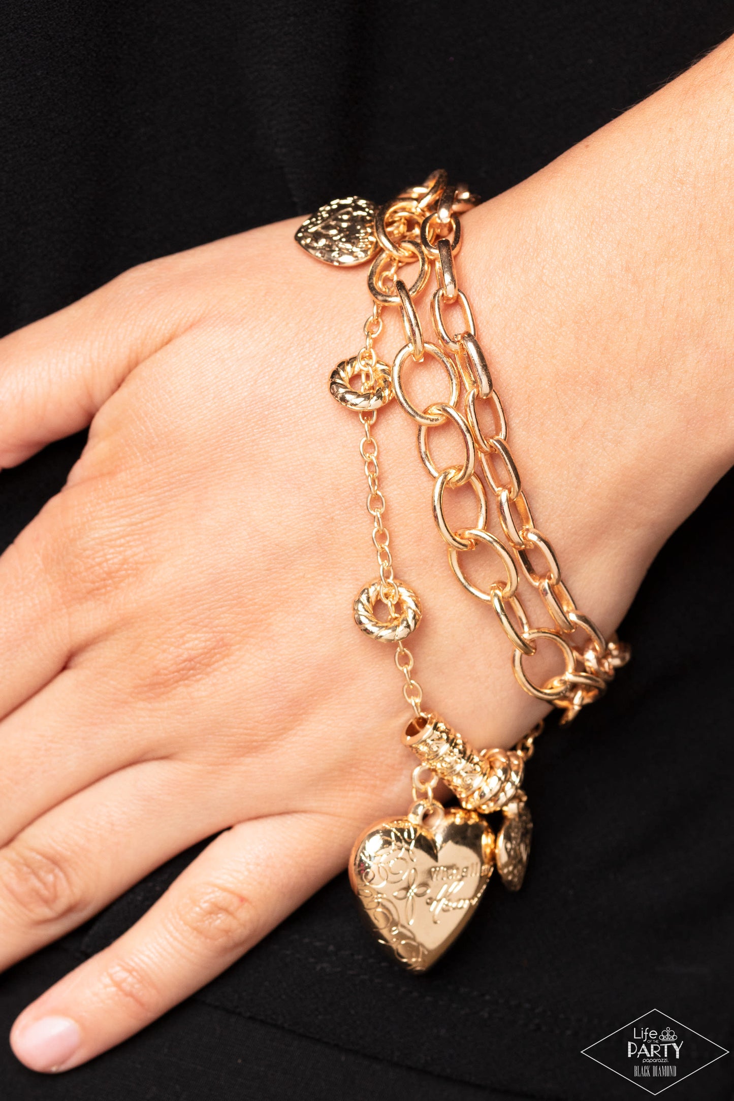 Paparazzi Accessories After My Own Heart - Gold A collection of gold hearts and gold rings combine with a larger heart charm adorned in a feminine floral pattern. The heart charm is inscribed with the phrase, "With All My Heart," on one side and a short b