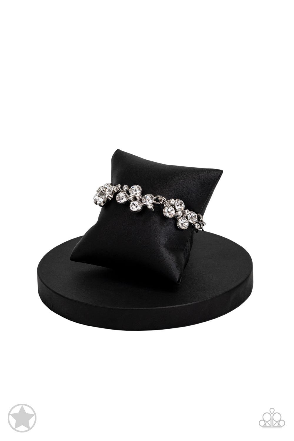 Paparazzi Accessories Old Hollywood Clusters of brilliant white rhinestones drape elegantly along the wrist. The scattered pattern and varying sizes of the rhinestones add breathtaking detail to the piece. Features an adjustable clasp closure. Sold as one