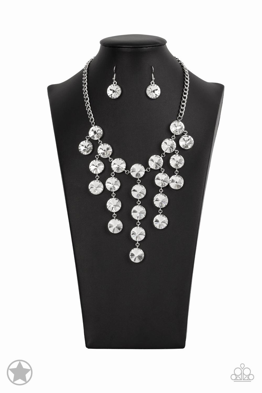 Paparazzi Accessories Spotlight Stunner - White Encased in sleek silver fittings, dramatically oversized white rhinestones delicately link into twinkly tassels that taper off into a jaw-dropping fringe below the collar. Features an adjustable clasp closur