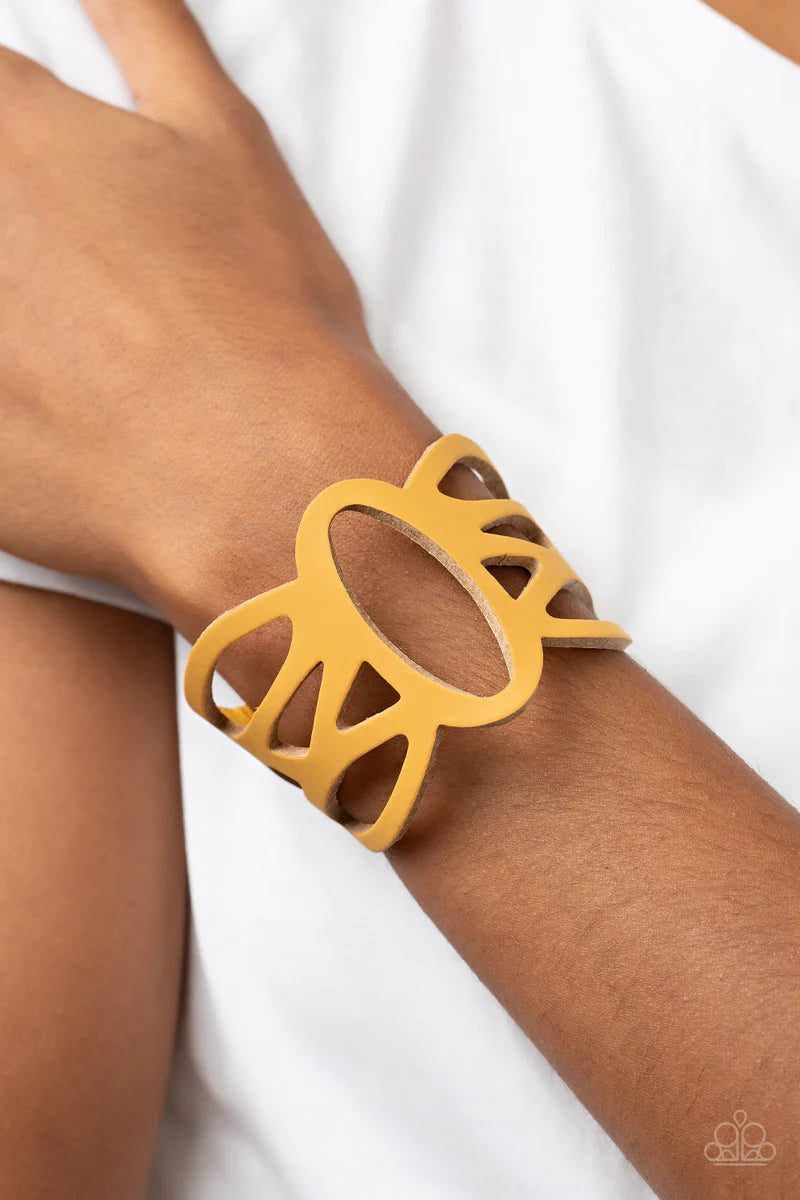 Paparazzi Accessories Rural Rodeo - Yellow A golden yellow leather band has been ornately cut into an airy stenciled pattern, allowing the skin to peek through the leather silhouettes for a natural look. Features an adjustable clasp closure. Sold as one i