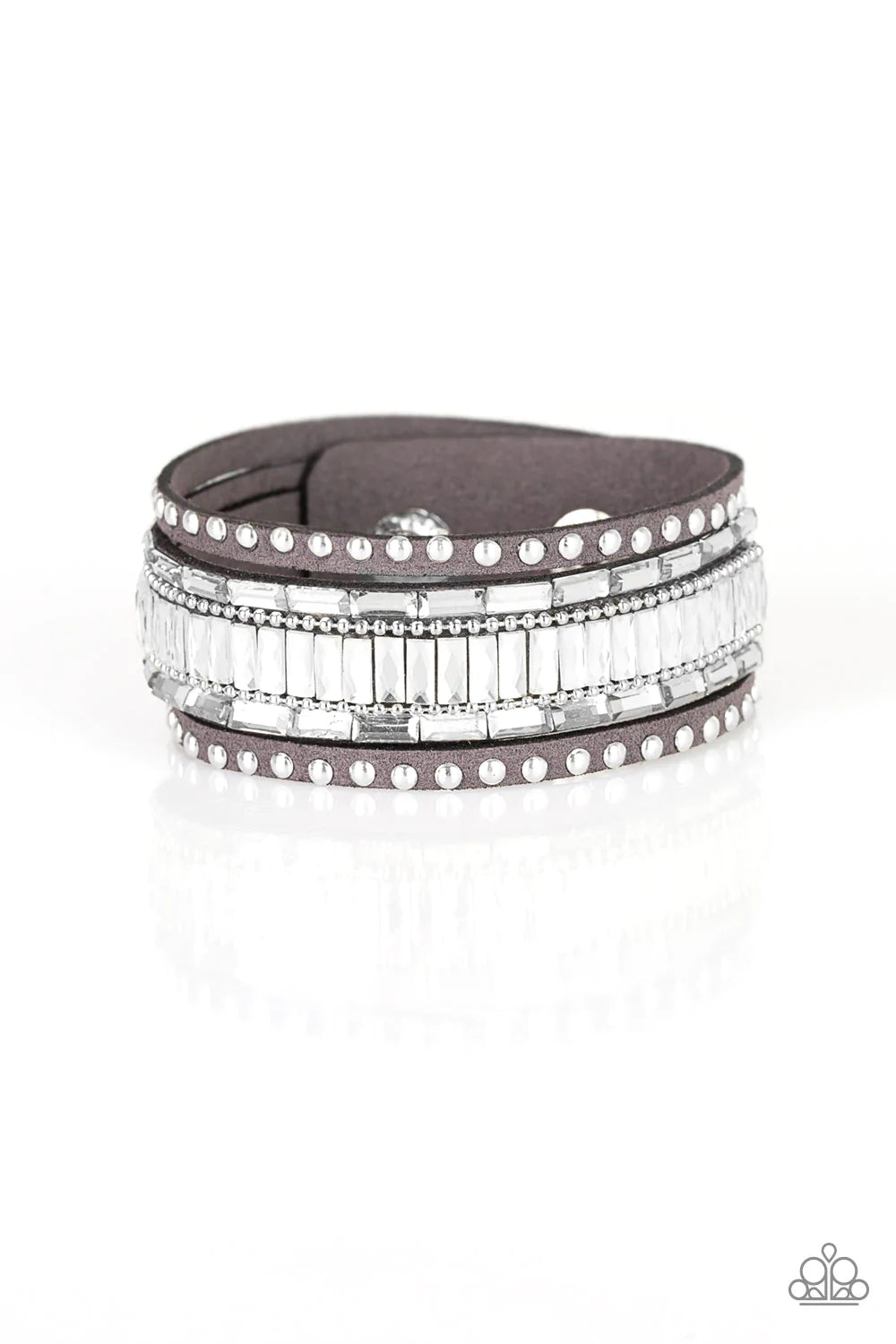 Paparazzi Accessories Rock Star Rocker - Silver Shiny silver studs, dainty silver ball chains, and edgy white emerald-cut rhinestones race along a spliced gray suede band for a rock star look. Features an adjustable snap closure. Sold as one individual br