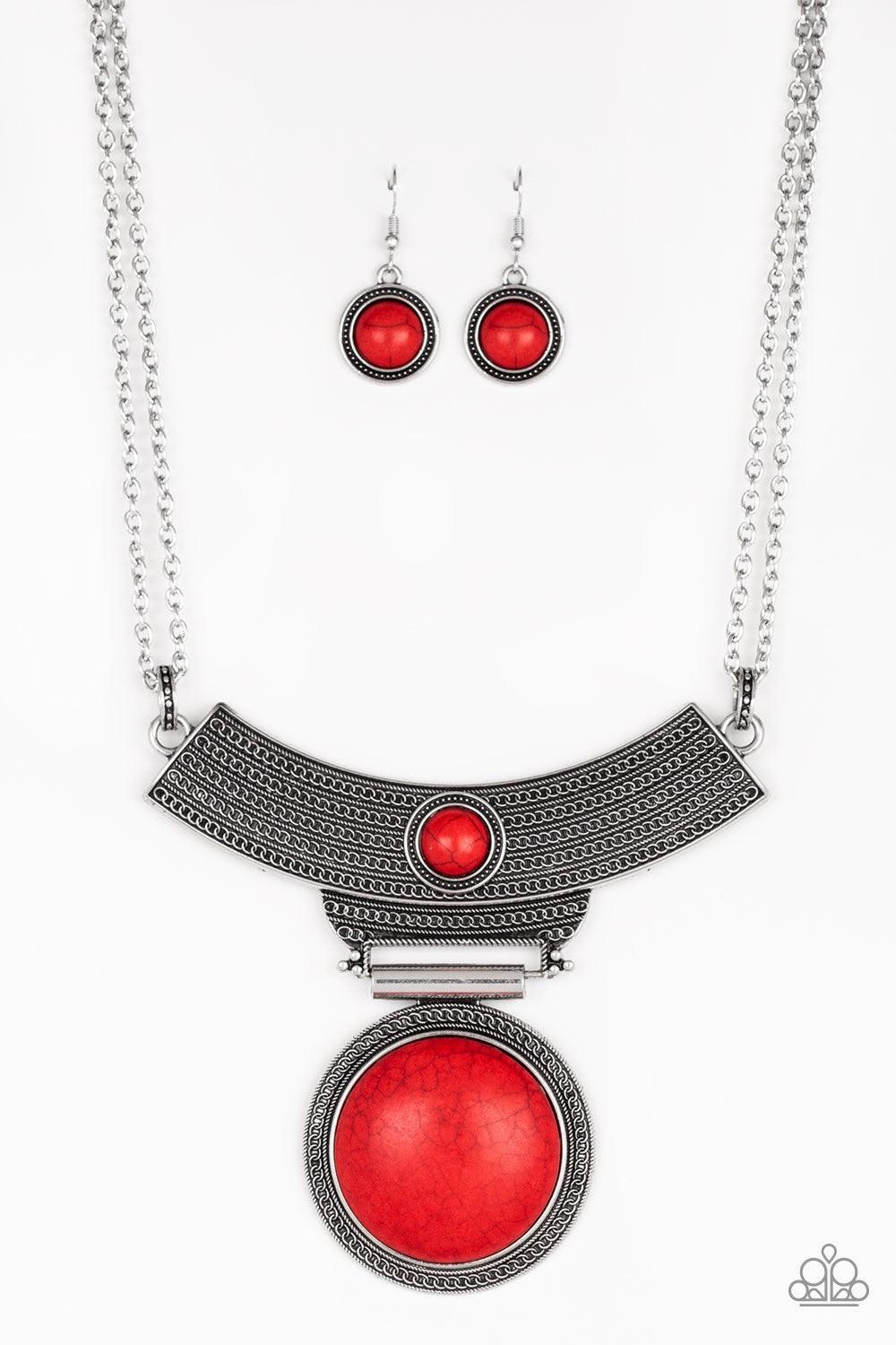 Paparazzi Accessories Lasting EMPRESS-ions - Red An antiqued silver plate, adorned in rippling circular textures, swings from the bottom of a pair of doubled silver chains. The ornate plate gives way to a dramatic red stone pendant bordered by tribal insp